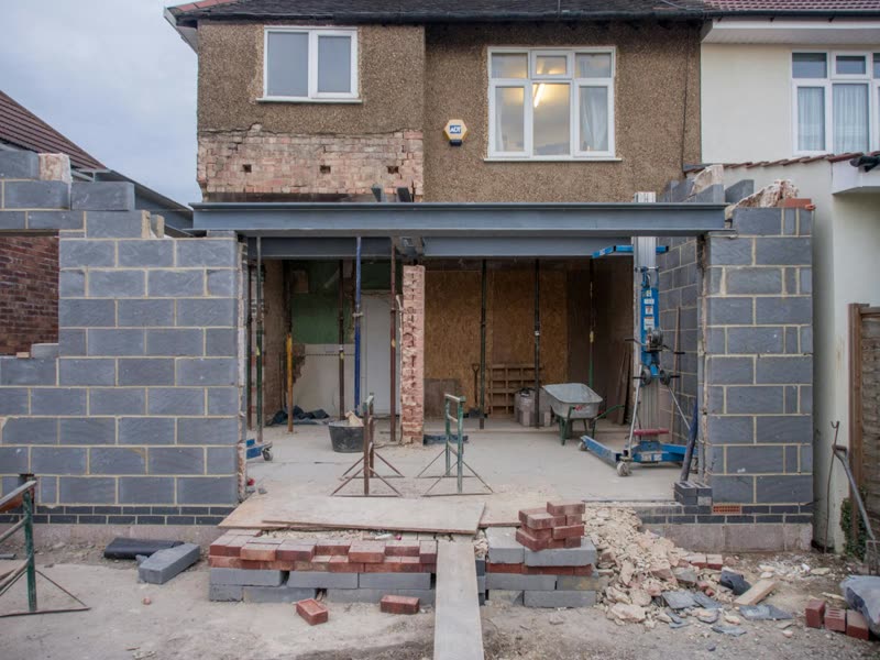 Double-storey rear extension under construction with structural steel beam visible