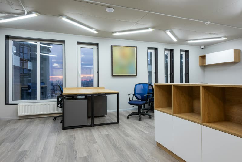 Modern open-plan office post fit-out with timber desks and exposed services